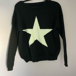 Black knit sweater with a big star